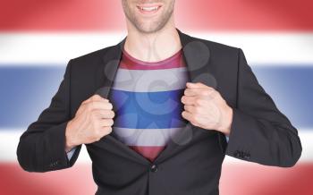 Businessman opening suit to reveal shirt with flag, Thailand