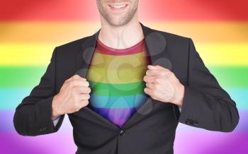 Businessman opening suit to reveal shirt with flag, rainbow flag