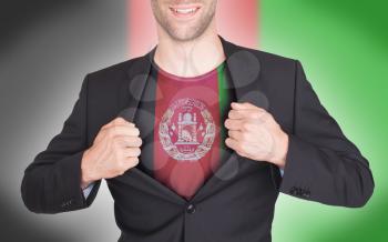 Businessman opening suit to reveal shirt with flag, Afghanistan