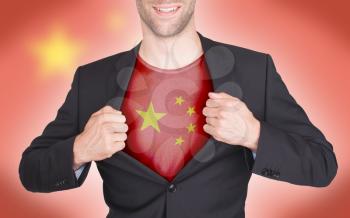 Businessman opening suit to reveal shirt with flag, China