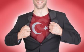 Businessman opening suit to reveal shirt with flag, Turkey