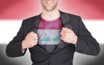 Businessman opening suit to reveal shirt with flag, Iraq