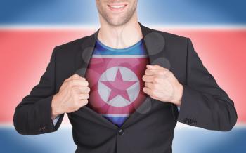 Businessman opening suit to reveal shirt with flag, North Korea