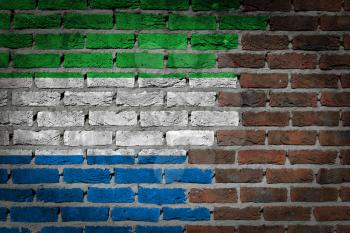Very old dark red brick wall texture with flag - Sierra Leone