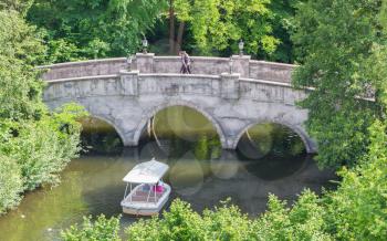 KAATSHEUVEL/THE NETHERLANDS - MAY 23th, 2014: Efteling park ride, boat with visitors, sails under an old brigde.