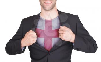Businessman opening suit to reveal shirt with flag, England