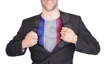 Businessman opening suit to reveal shirt with flag, France