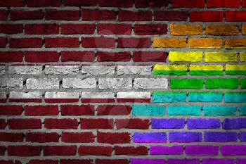 Dark brick wall texture - coutry flag and rainbow flag painted on wall - Latvia