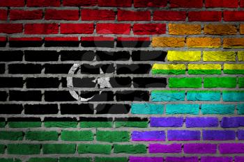 Dark brick wall texture - coutry flag and rainbow flag painted on wall - Libya
