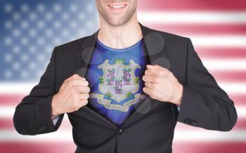 Businessman opening suit to reveal shirt with state flag (USA), Connecticut