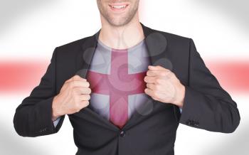 Businessman opening suit to reveal shirt with flag, England