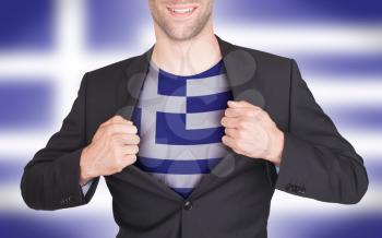 Businessman opening suit to reveal shirt with flag, Greece
