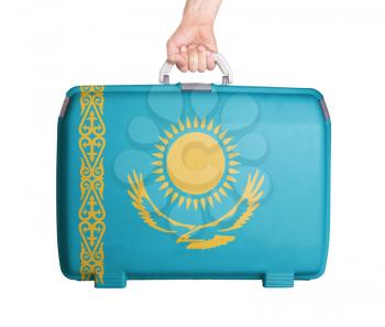Used plastic suitcase with stains and scratches, printed with flag, Kazakhstan