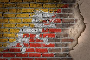 Dark brick wall texture with plaster - flag painted on wall - Bhutan