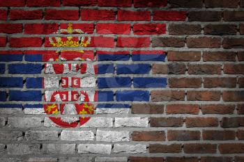 Very old dark red brick wall texture with flag - Serbia