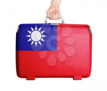 Used plastic suitcase with stains and scratches, printed with flag, Taiwan