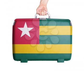 Used plastic suitcase with stains and scratches, printed with flag, Togo
