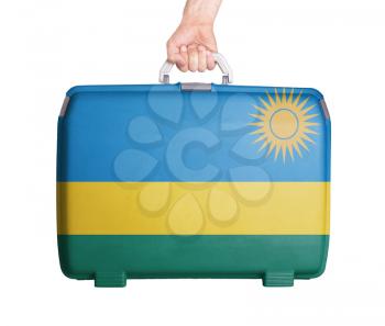 Used plastic suitcase with stains and scratches, printed with flag, Rwanda