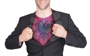 Businessman opening suit to reveal shirt with flag, Albania