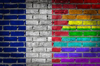 Dark brick wall texture - coutry flag and rainbow flag painted on wall - France