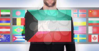 Hand pushing on a touch screen interface, choosing language or country, Kuwait