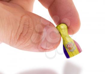 Hand holding wooden pawn with a flag painting, selective focus, Andorra