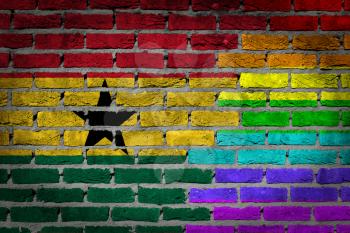 Dark brick wall texture - coutry flag and rainbow flag painted on wall - Ghana