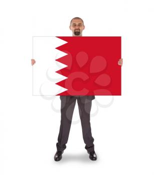Businessman holding a big card, flag of Bahrain, isolated on white