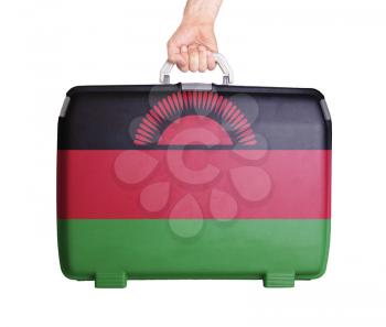 Used plastic suitcase with stains and scratches, printed with flag, Malawi
