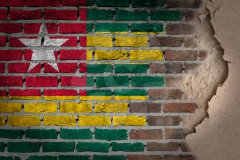 Dark brick wall texture with plaster - flag painted on wall - Togo