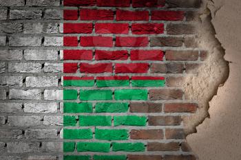 Dark brick wall texture with plaster - flag painted on wall - Madagascar