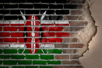 Dark brick wall texture with plaster - flag painted on wall - Kenya