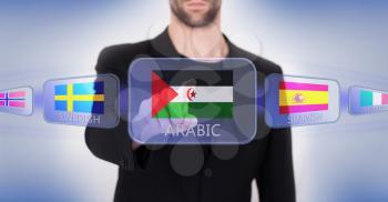 Hand pushing on a touch screen interface, choosing language or country, Western Sahara