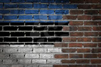 Very old dark red brick wall texture with flag - Estonia