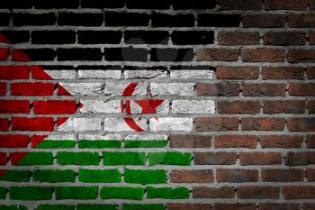 Very old dark red brick wall texture with flag - Western Sahara
