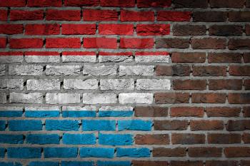 Very old dark red brick wall texture with flag - Luxembourg