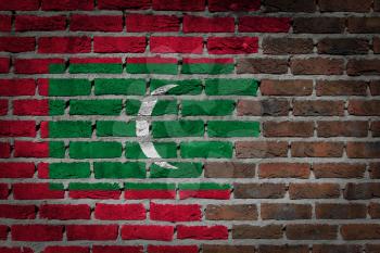 Very old dark red brick wall texture with flag - Maldives