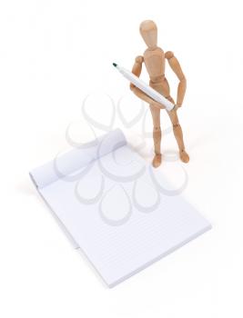 Wooden mannequin writing in a scrapbook, isolated