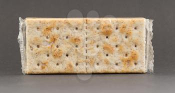 Crackers in plastic, isolated on a grey background