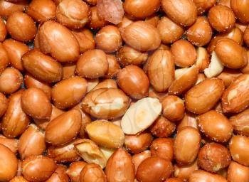Stack of unshelled peanuts, salted - Food background