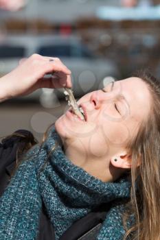 Dutch woman is eating typical raw herring with onions
