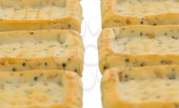Simple square crackers isolated on a white background, selective focus