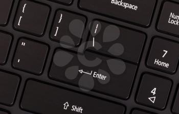Black modern laptop keyboard close up, enter