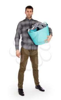 Full length portrait of a young man holding a laundry basket isolated on white background