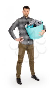 Full length portrait of a young man holding a laundry basket isolated on white background