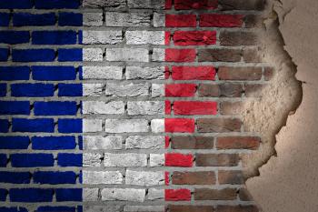 Dark brick wall texture with plaster - flag painted on wall - France