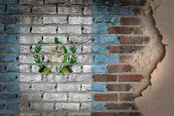 Dark brick wall texture with plaster - flag painted on wall - Guatemala