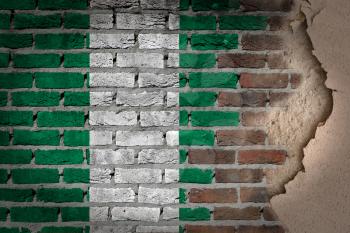 Dark brick wall texture with plaster - flag painted on wall - Nigeria