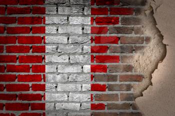 Dark brick wall texture with plaster - flag painted on wall - Peru
