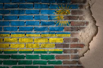 Dark brick wall texture with plaster - flag painted on wall - Rwanda